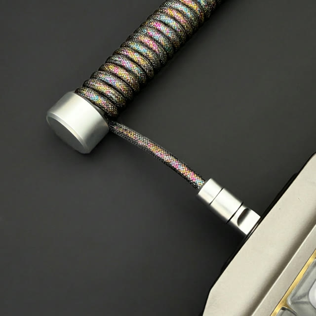 Close-up of a multicolour braided keyboard cable coil and metal end cap